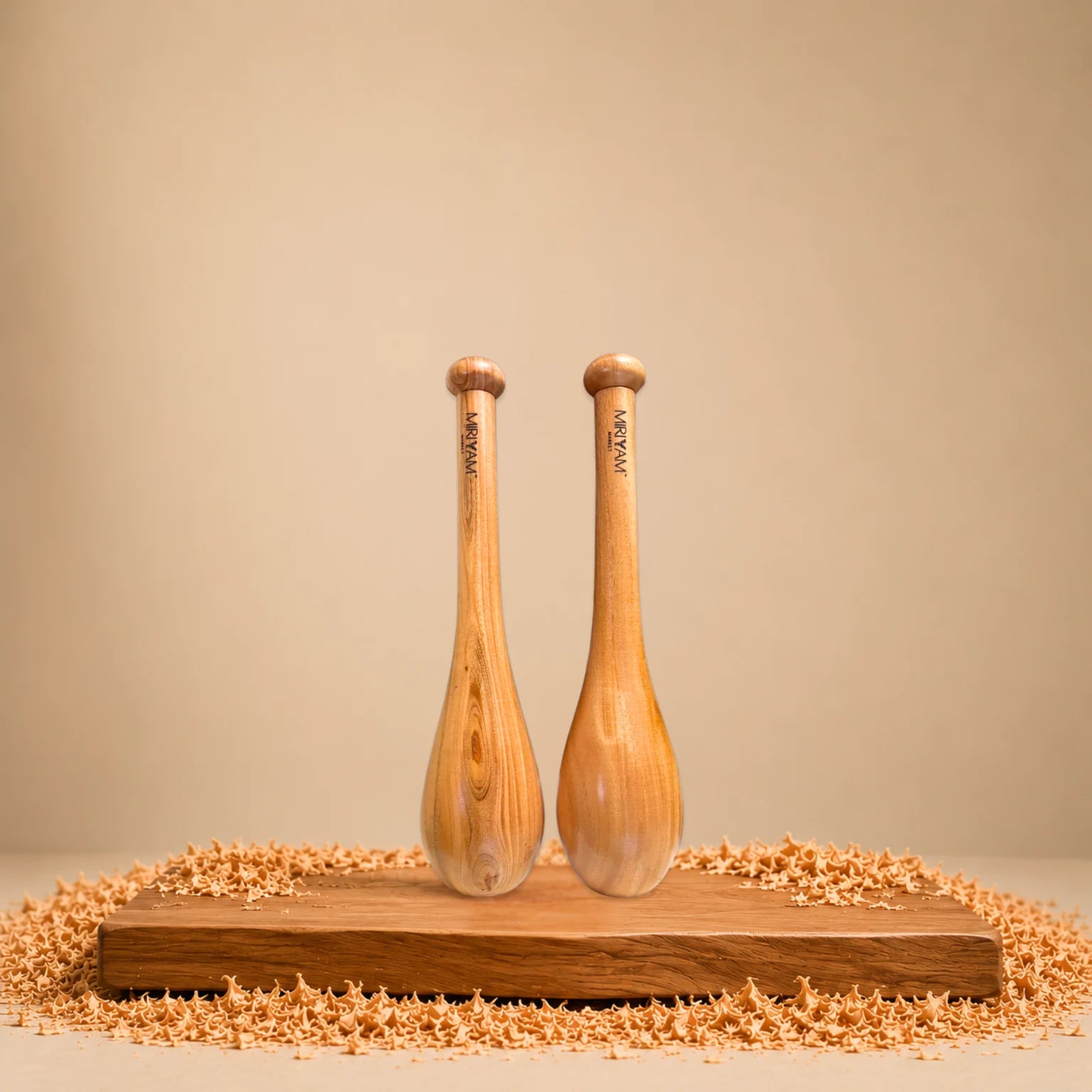 Wooden Indian clubs on a wooden platform with a beige background