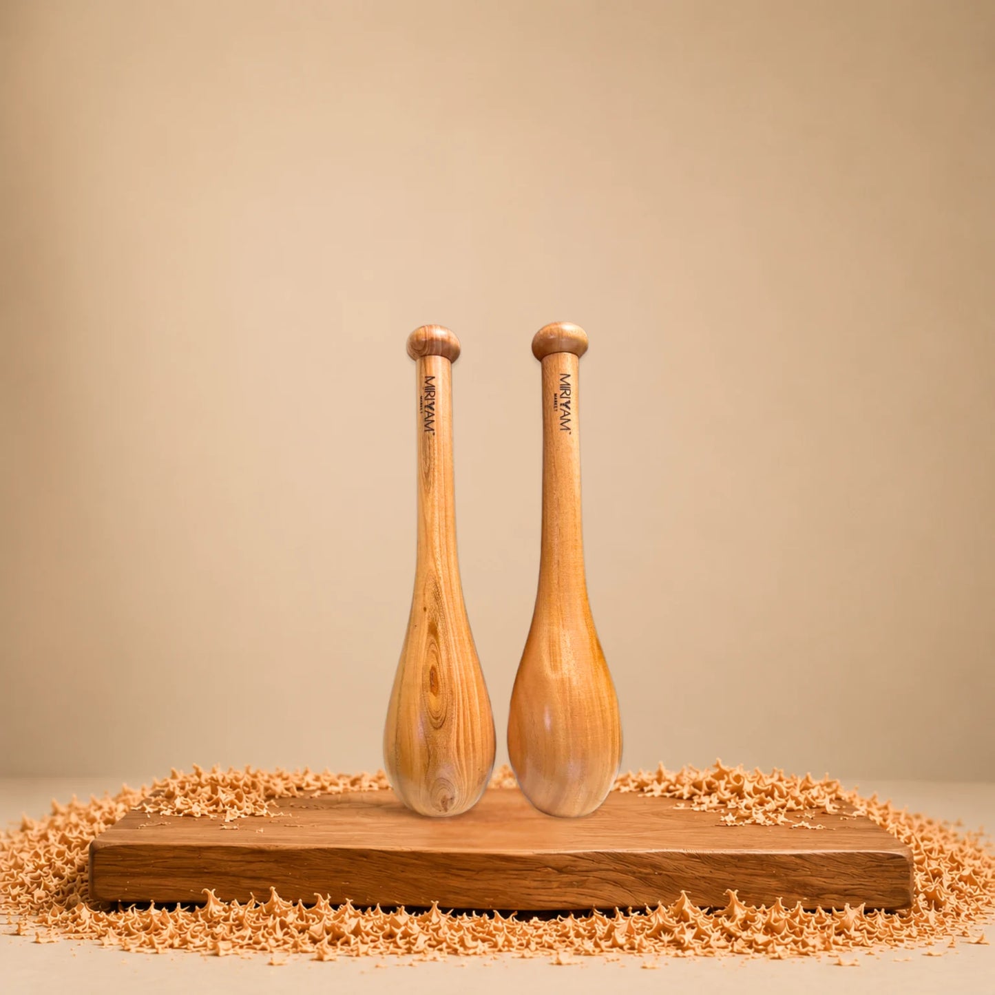 Wooden Indian clubs on a wooden platform with a beige background